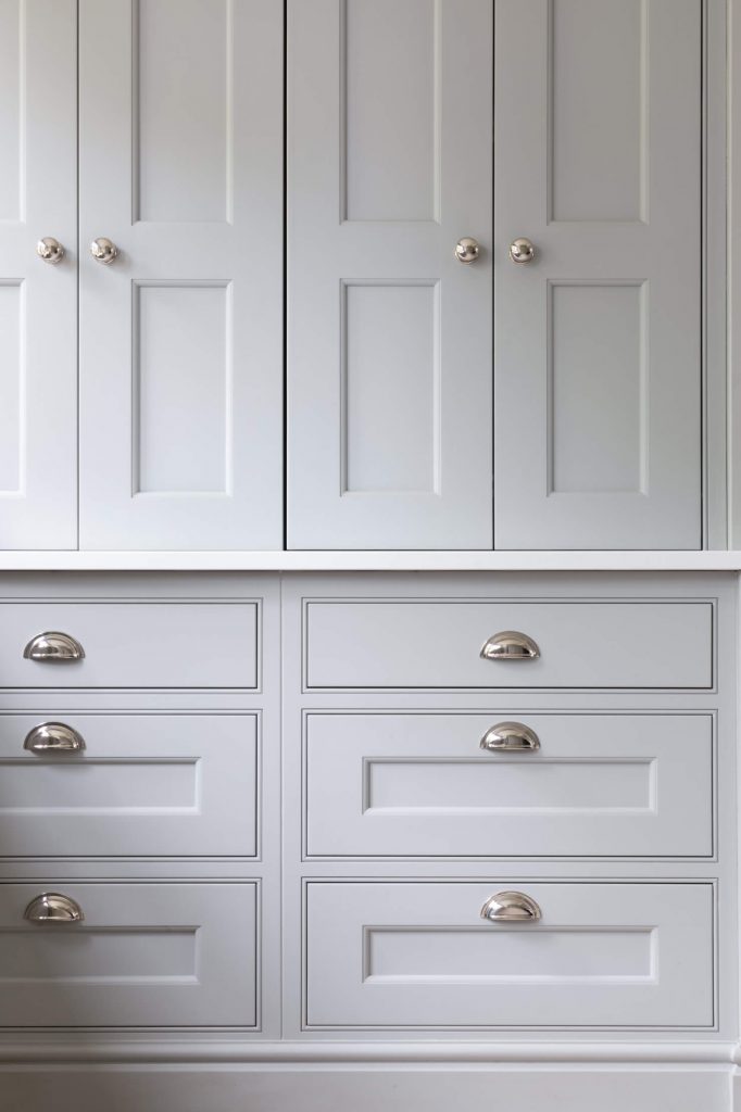 Gorgeous white shaker cabinetry with silver handle cups that works as a breakfast cupboard. Quartz worktop with extra sink and small appliances like coffee, maker, toaster and microwave.