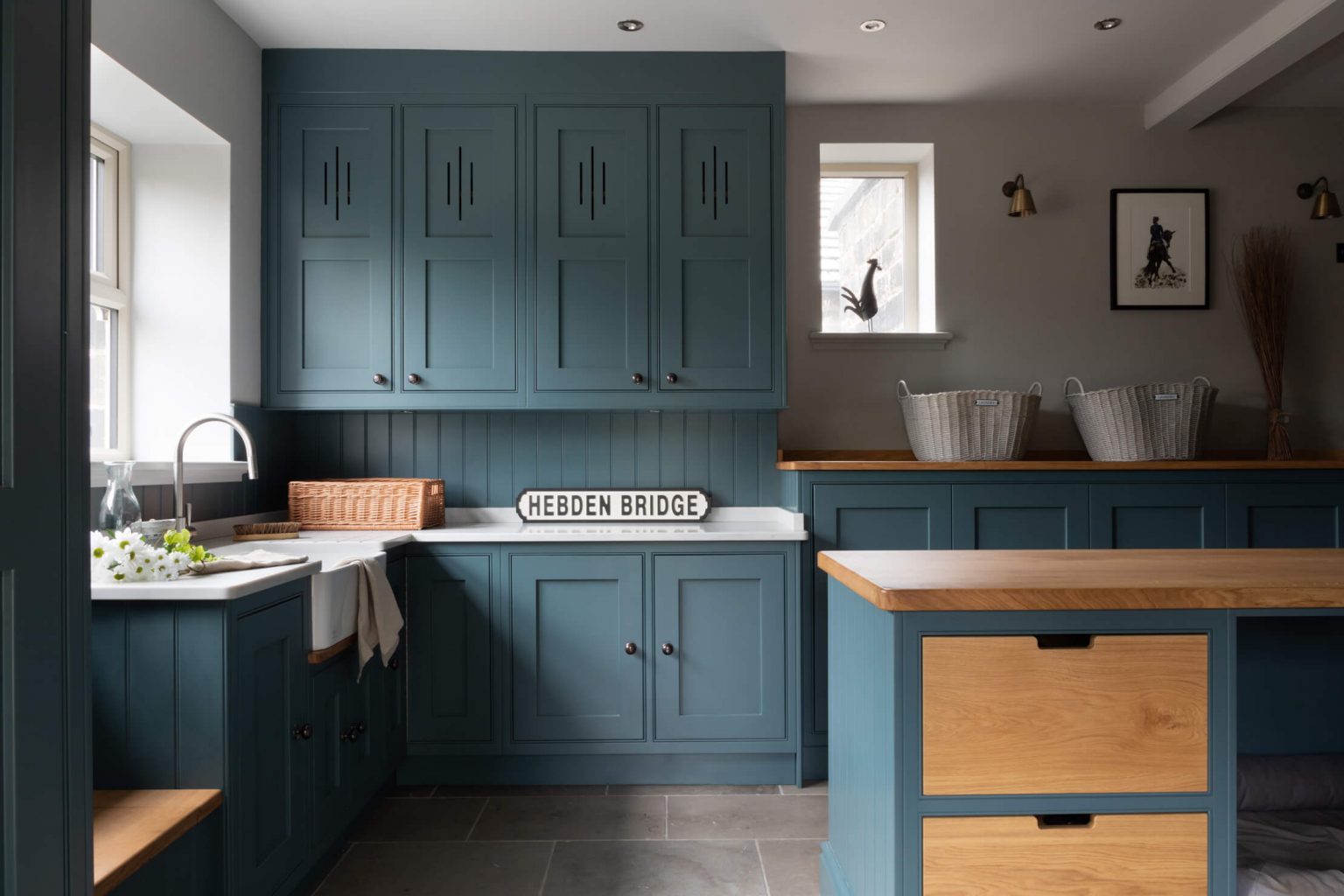 Bespoke cabinetry in a boot room with a sink, extra freezer and fridge, dog bed and more hidden utilities in sstiffkey blue farrow and ball.