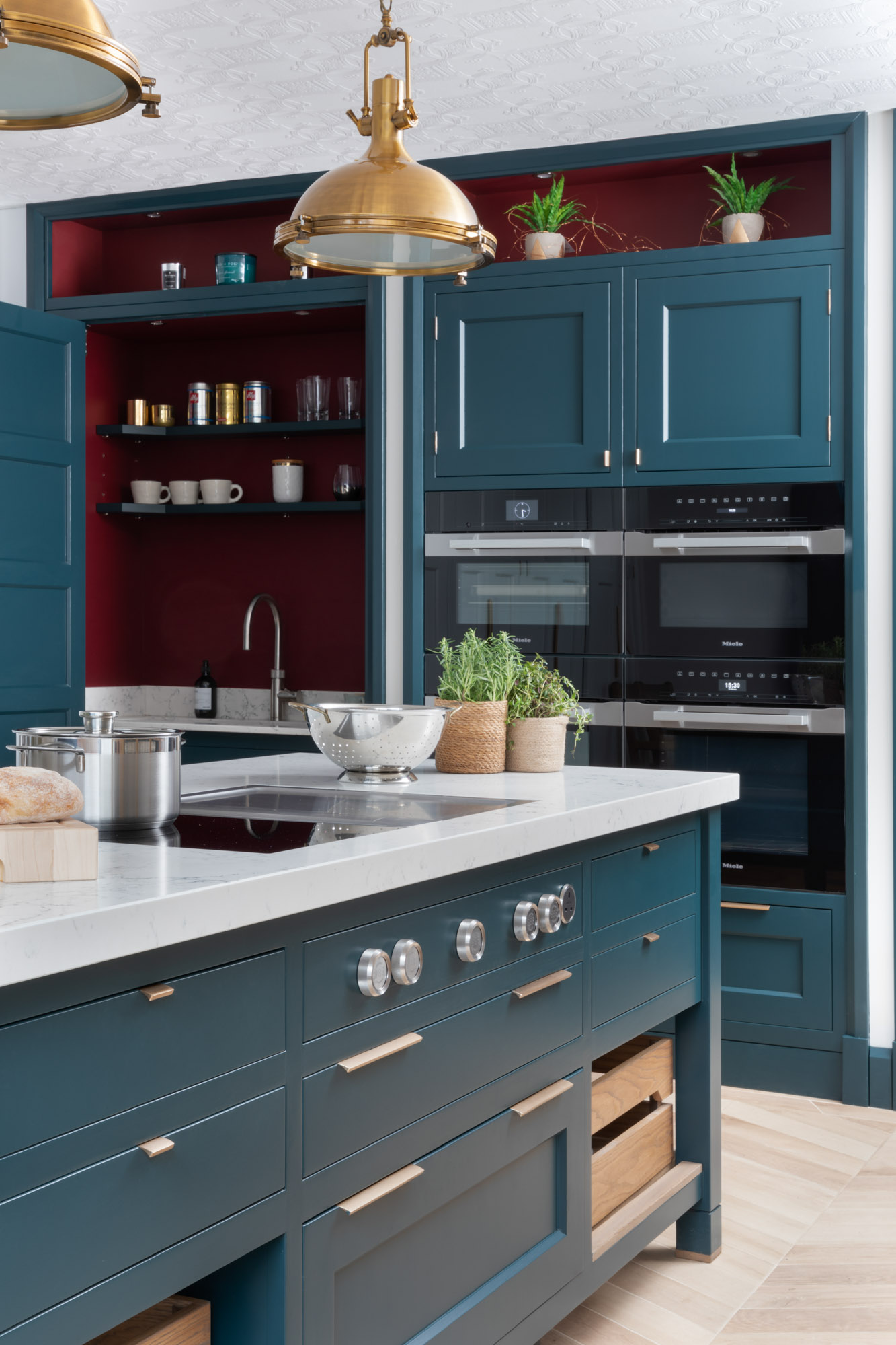 Smoky blue kitchen design with integrated appliances oven dishwasher and bora hob and an extra sink with a quooker tap