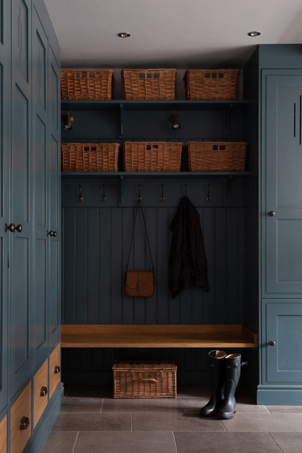 Bespoke boot room in smoky blue with stone flooring